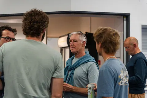 A small group talking in the foyer by the bar